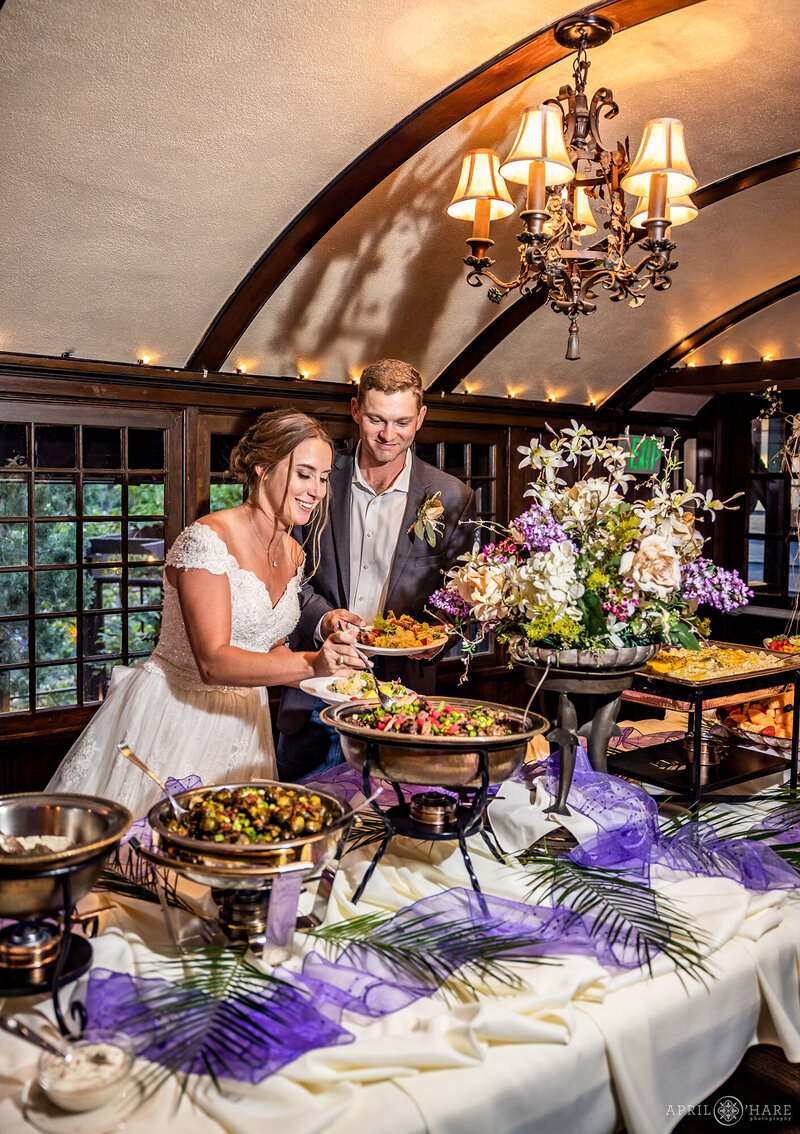 Wedding Couple at their Dinner Buffet at Craftwood Peak Wedding Venue in Manitou Springs CO