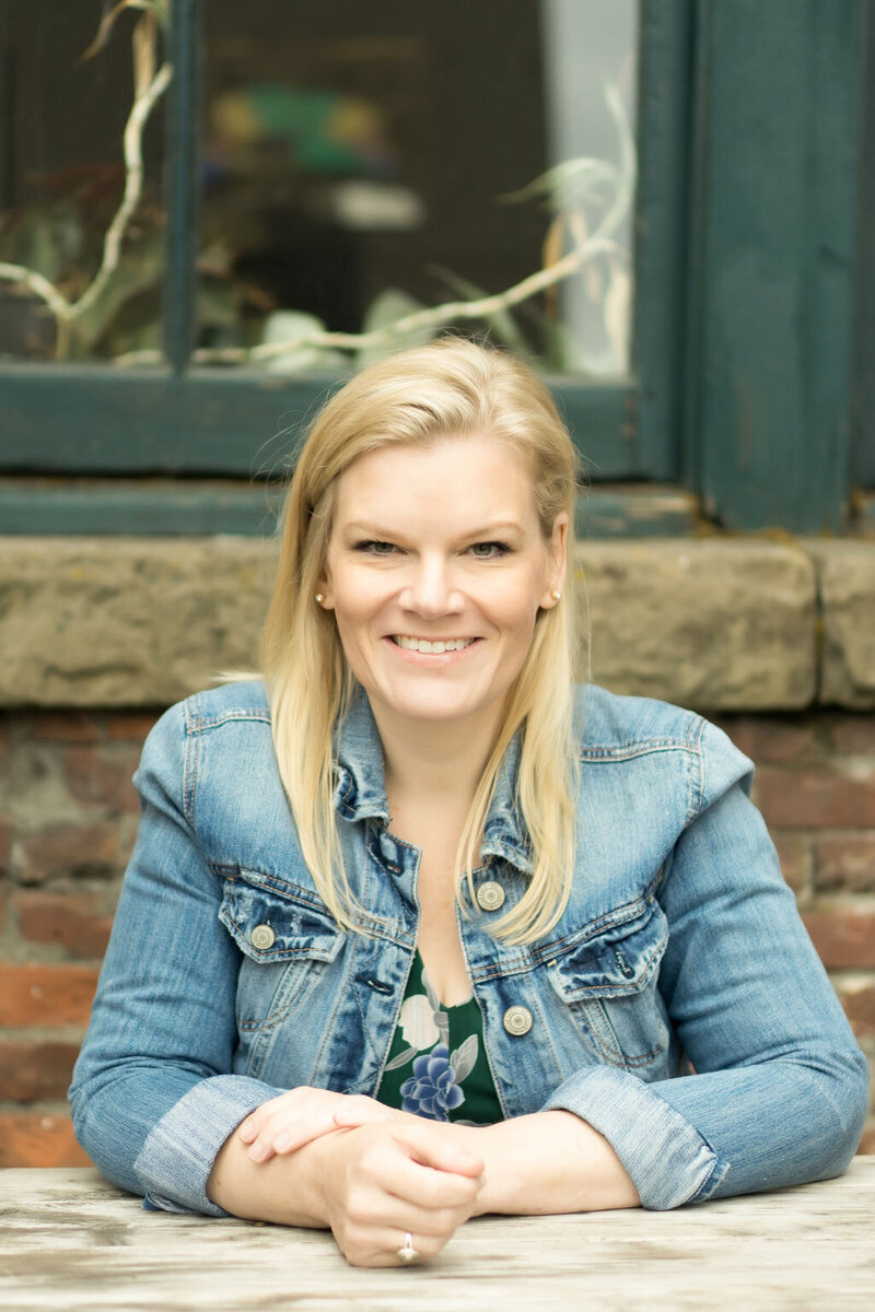 woman with blonde hair and  denim jacket