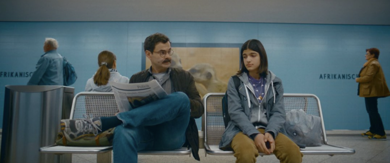 A group of teenagers standing on a football field, captured in warm, natural light.