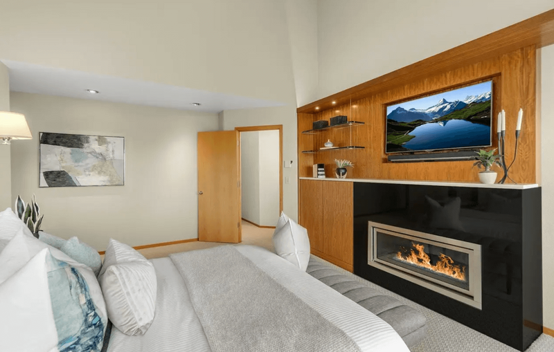 A bedroom featuring a bed and built in fireplace.