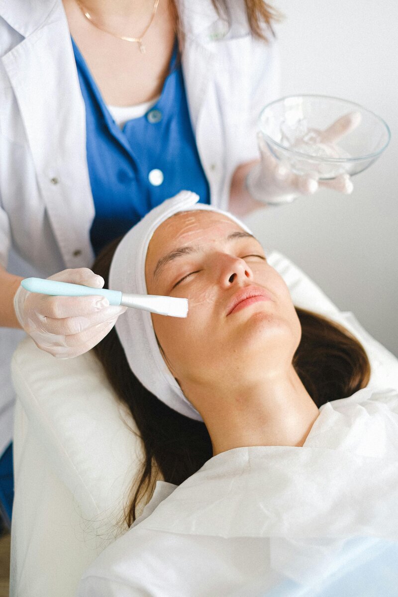 Client enjoying a calming, customized facial experience in Montreal spa studio
