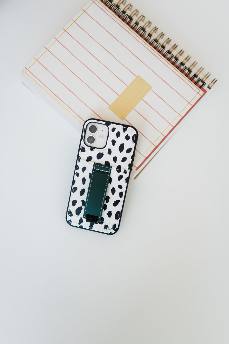 A notebook with a cell phone stacked on top