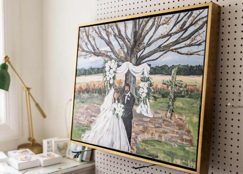 Miriam painting couple at wedding in wood barn