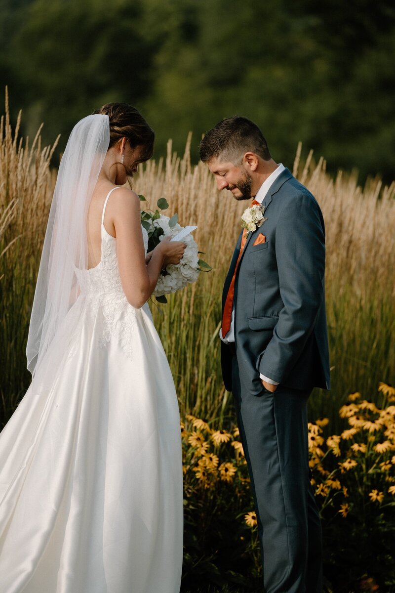 bride and groom reading private vows