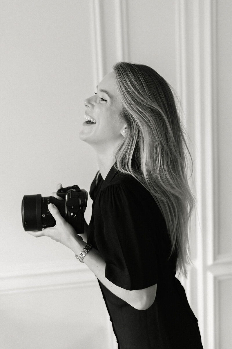 Portrait of Katya Joseph smiling with her camera, luxury wedding photographer in London
