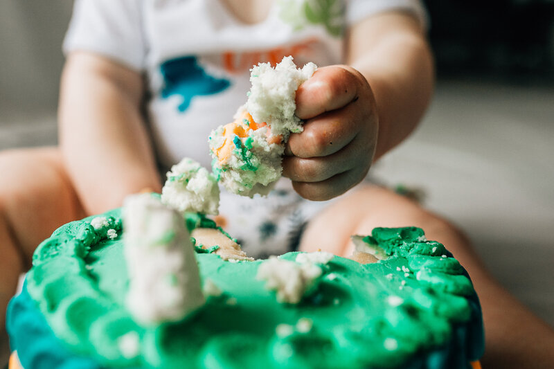 Baby playing with birthday cake