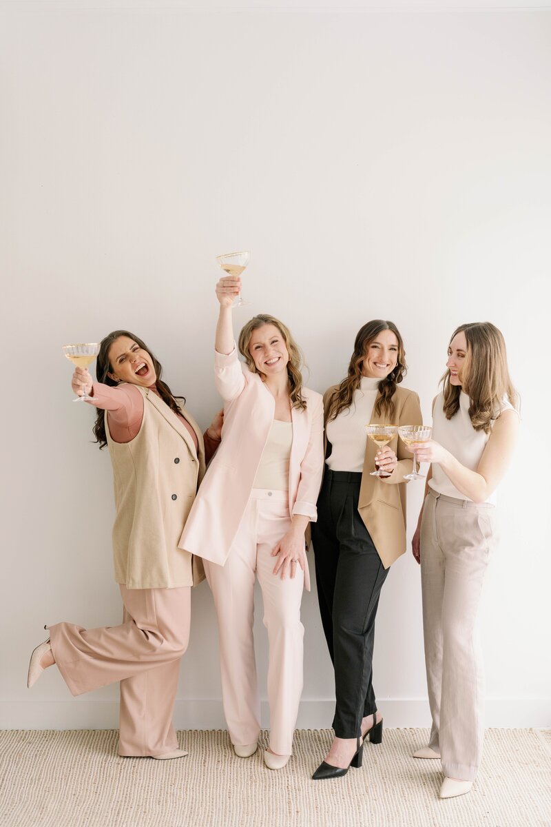 4 team members with champagne glasses
