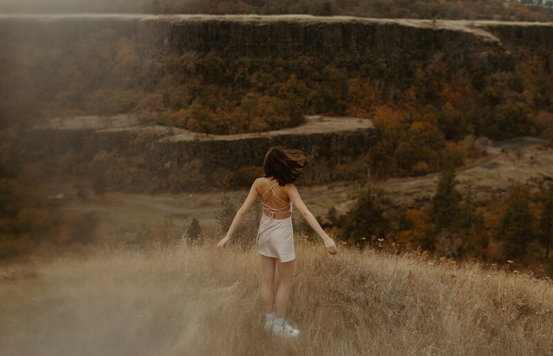 girl standing on hillside