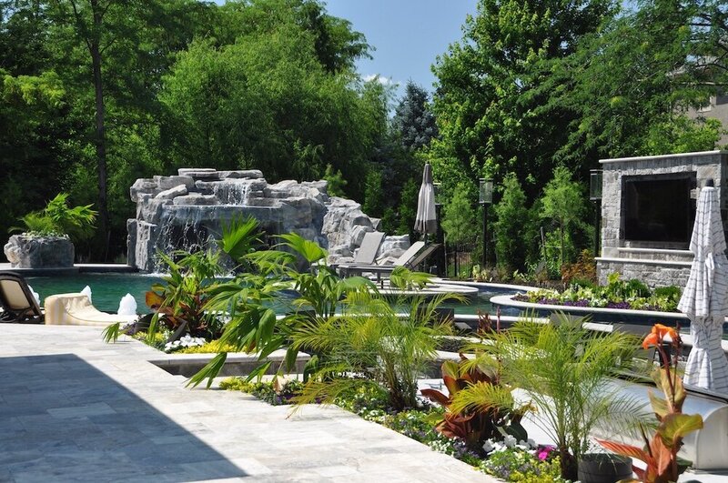 An impeccably maintained landscape by a pool 