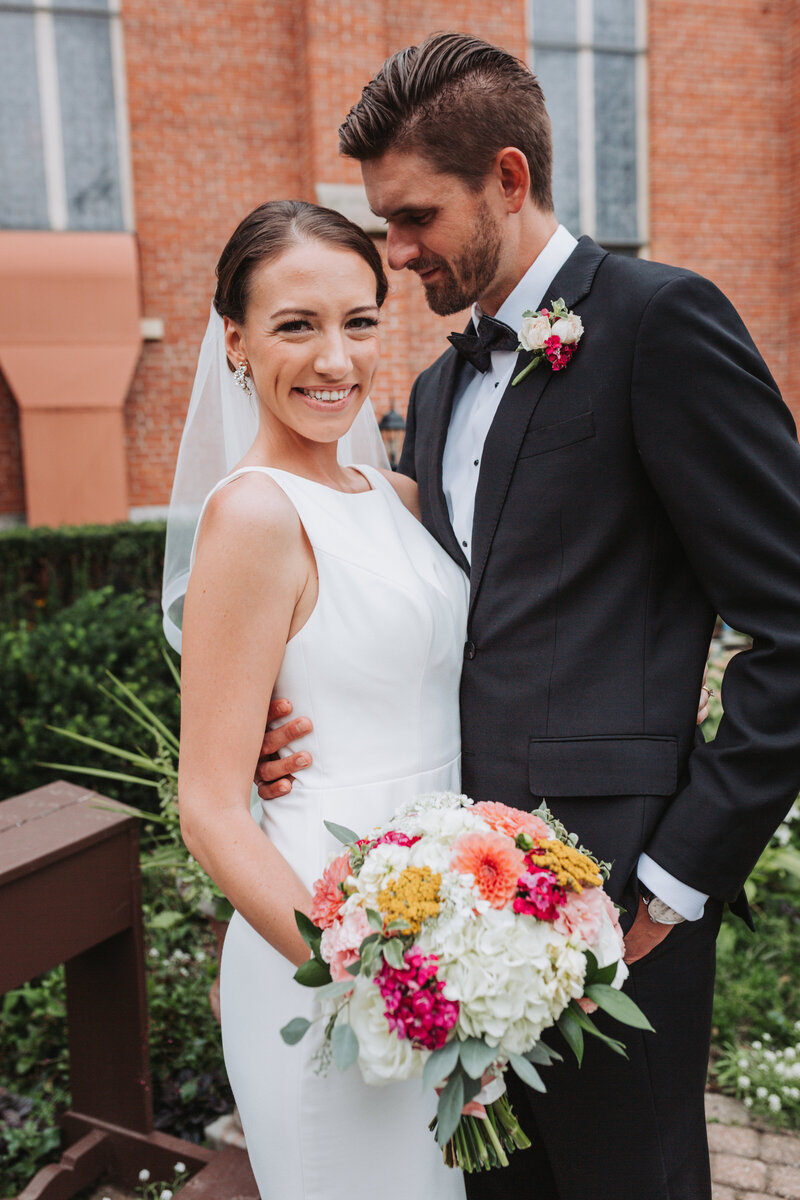 Portrait of bride and groom outside of their church ceremony