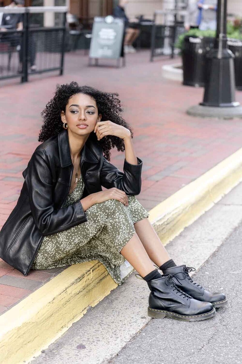 girl sitting on the sidewalk taken by senior photographer in Reston, Virginia