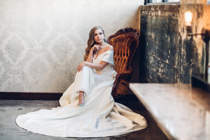 A bride in a white wedding dress sitting in a chair captured by photographer for destination weddings Britt Elizabeth.