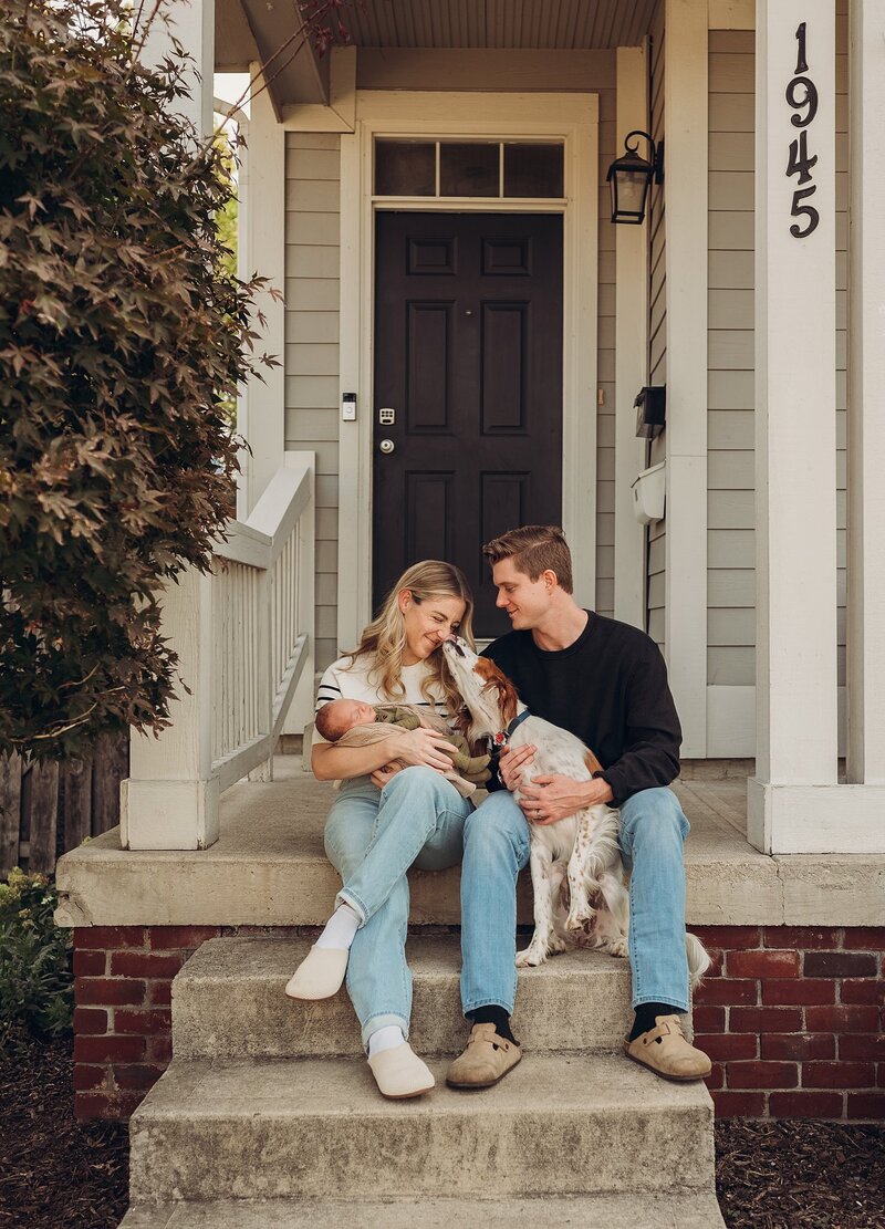 Family holding baby on porch