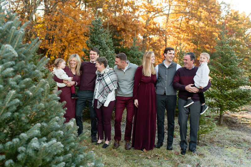 Extended family laughing at one another at Christmas Tree Farm