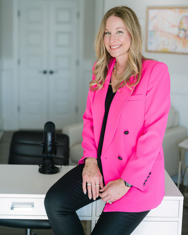 April Likins Top Stress Management Coach sitting on her desk in her office