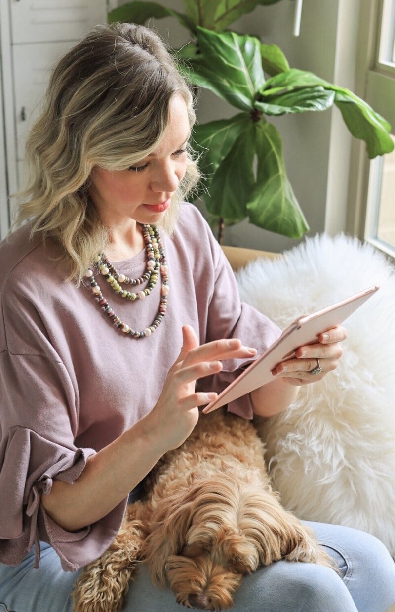 girl on ipad with dog