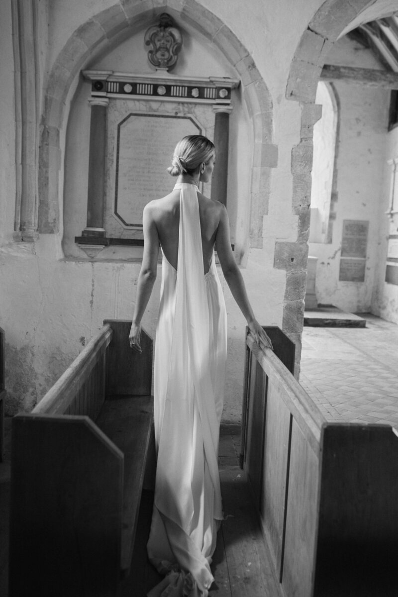 Sleeveless silk high neck wedding dress by British designer