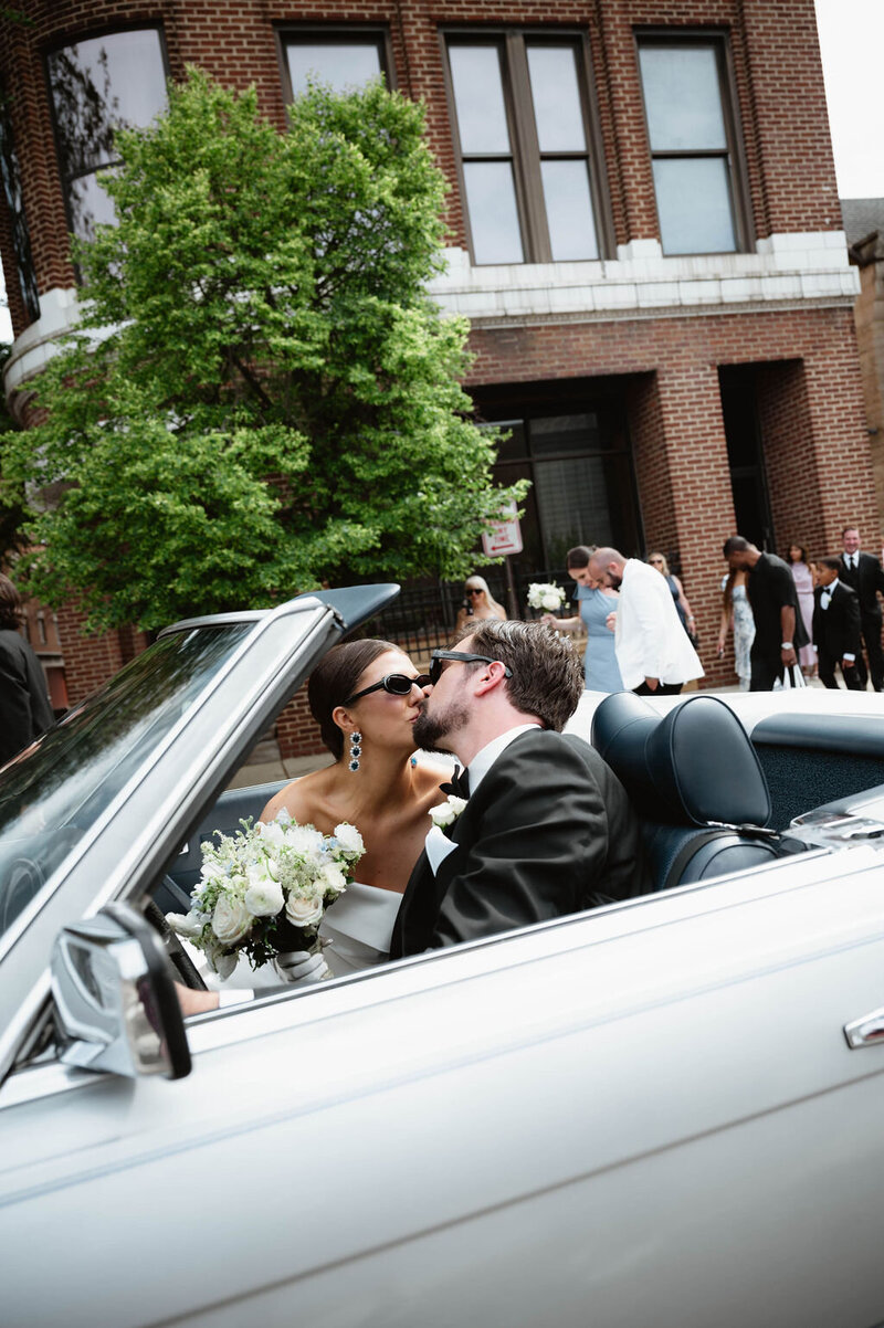 Bride and groom post together on rooftop