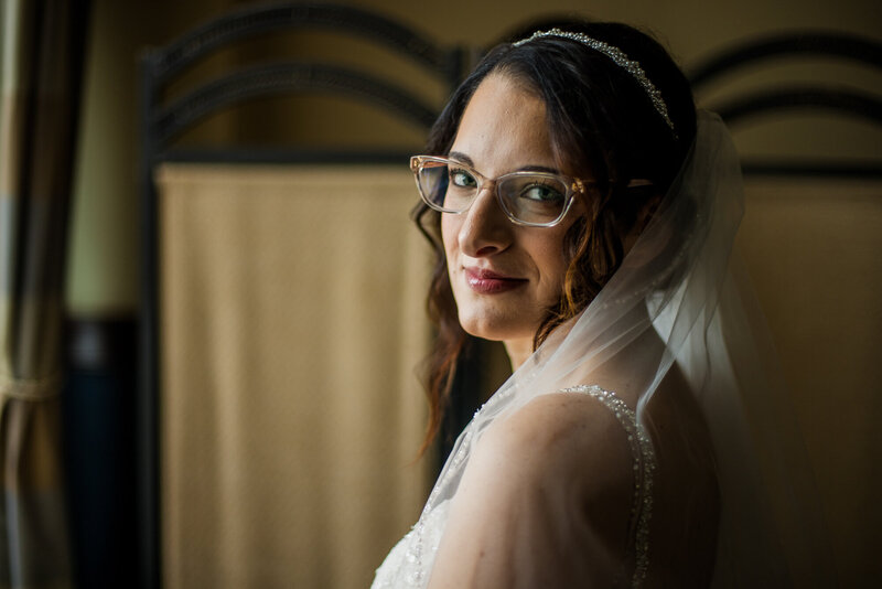 Solo portrait of bride looking over her shoulder at the camera