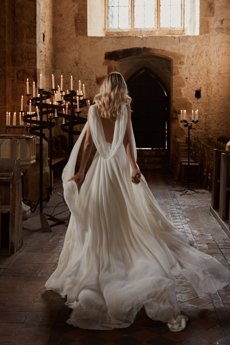 Bride wearing low back wedding dress with deep v neck, in handmade silk by British designer