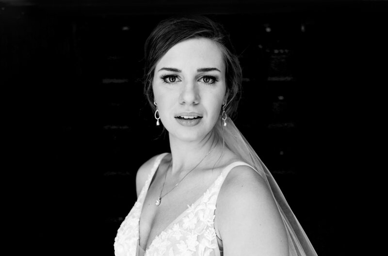 a beautiful black and white photo of a bride looking at the camera with catchlights in her eyes at Nazareth Hall in Toledo Ohio