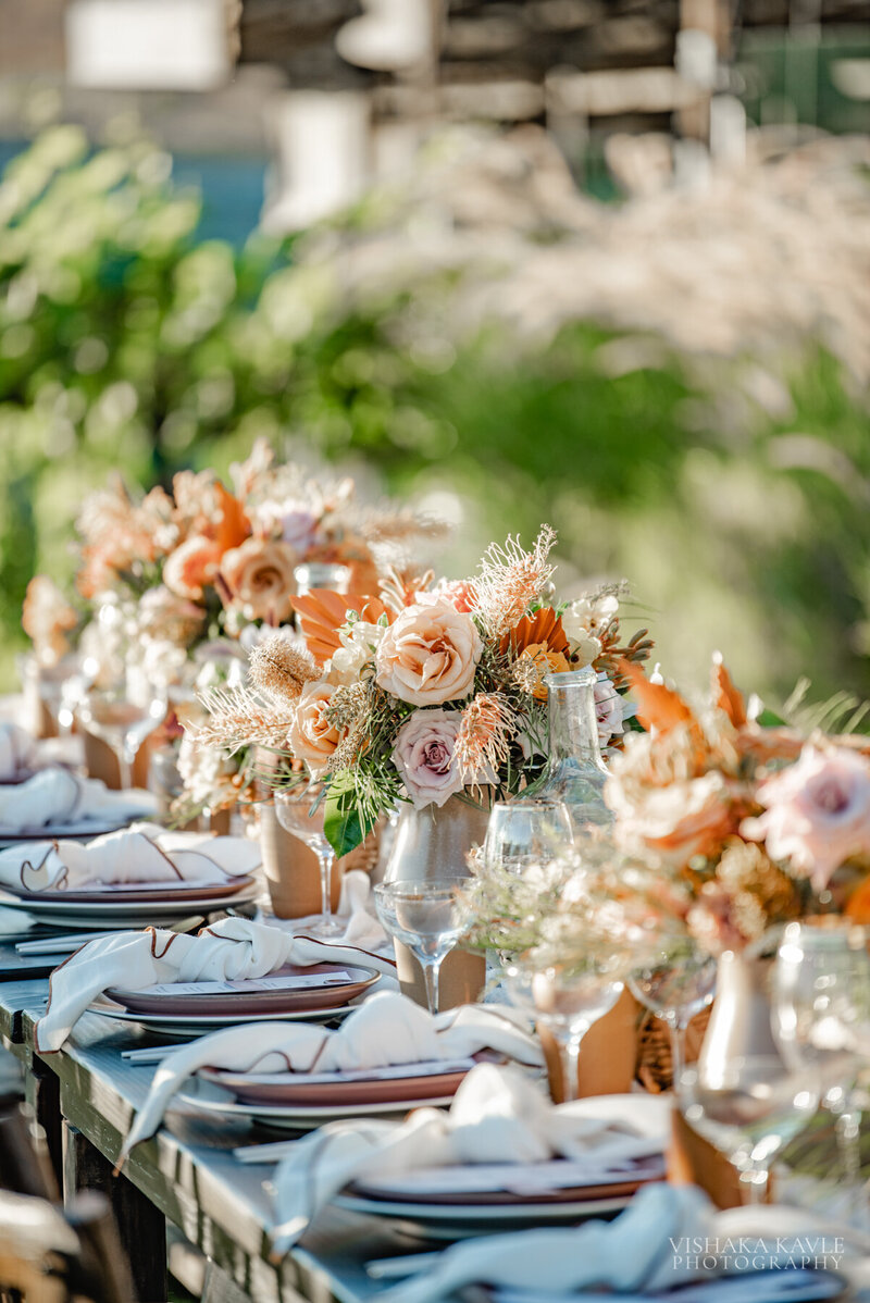 place settings with flowers at a wedding reception table
