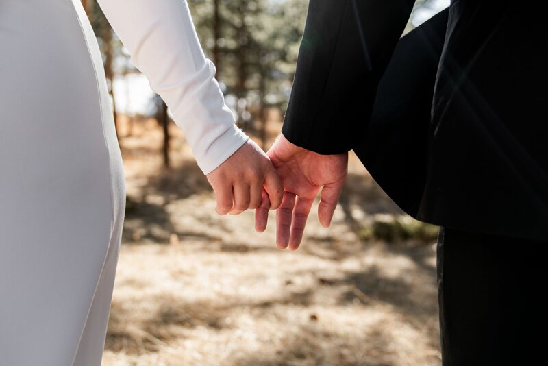 bride and groom holding hands
