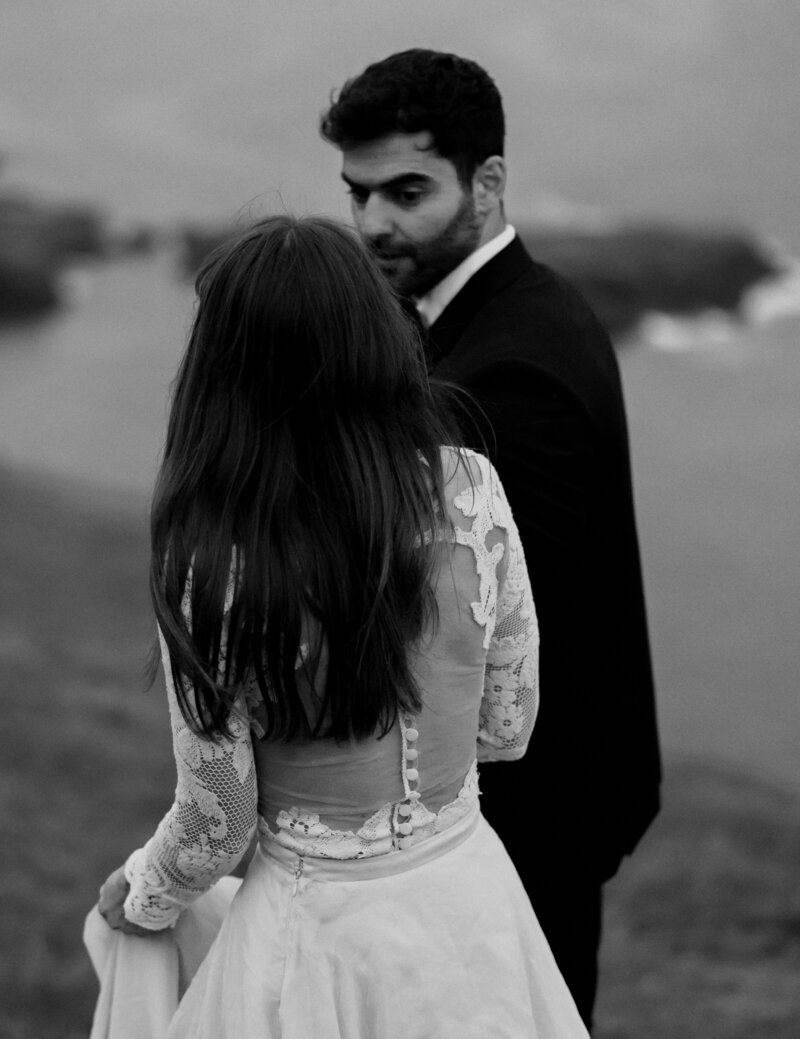 Faroe Islands elopement portraits – bride and groom laughing in the wind, by Kollar Photography.