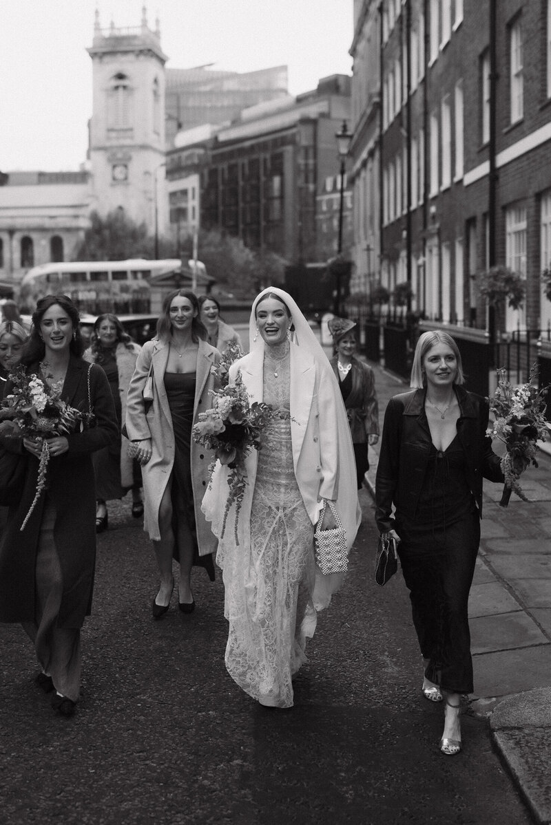 An emotional bride hugs her husband at their luxury wedding reception in the cotswolds
