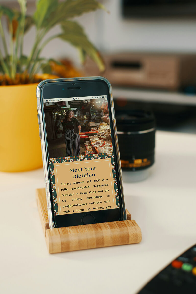 Moody and inclusive nutritionist website design displayed on a mobile device.