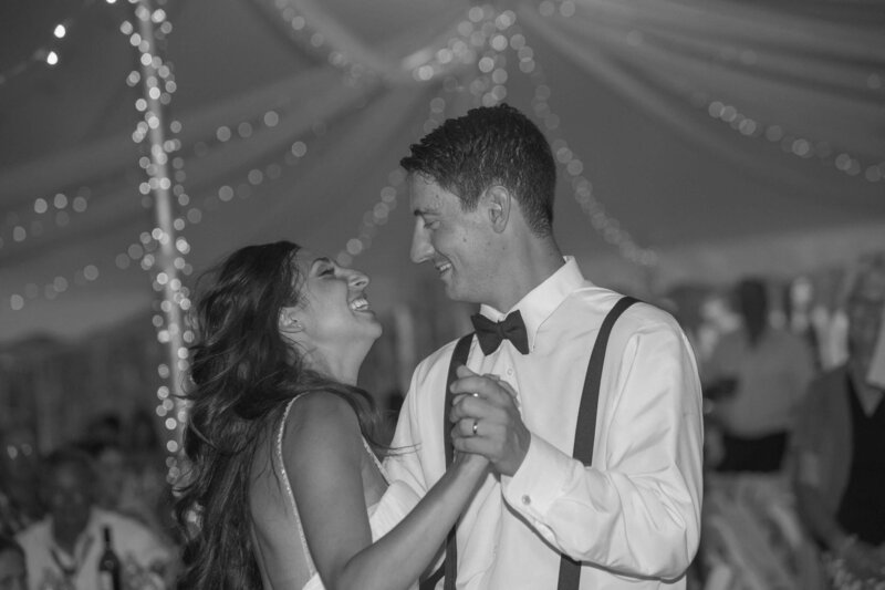 bride and groom dancing  while looking at each other