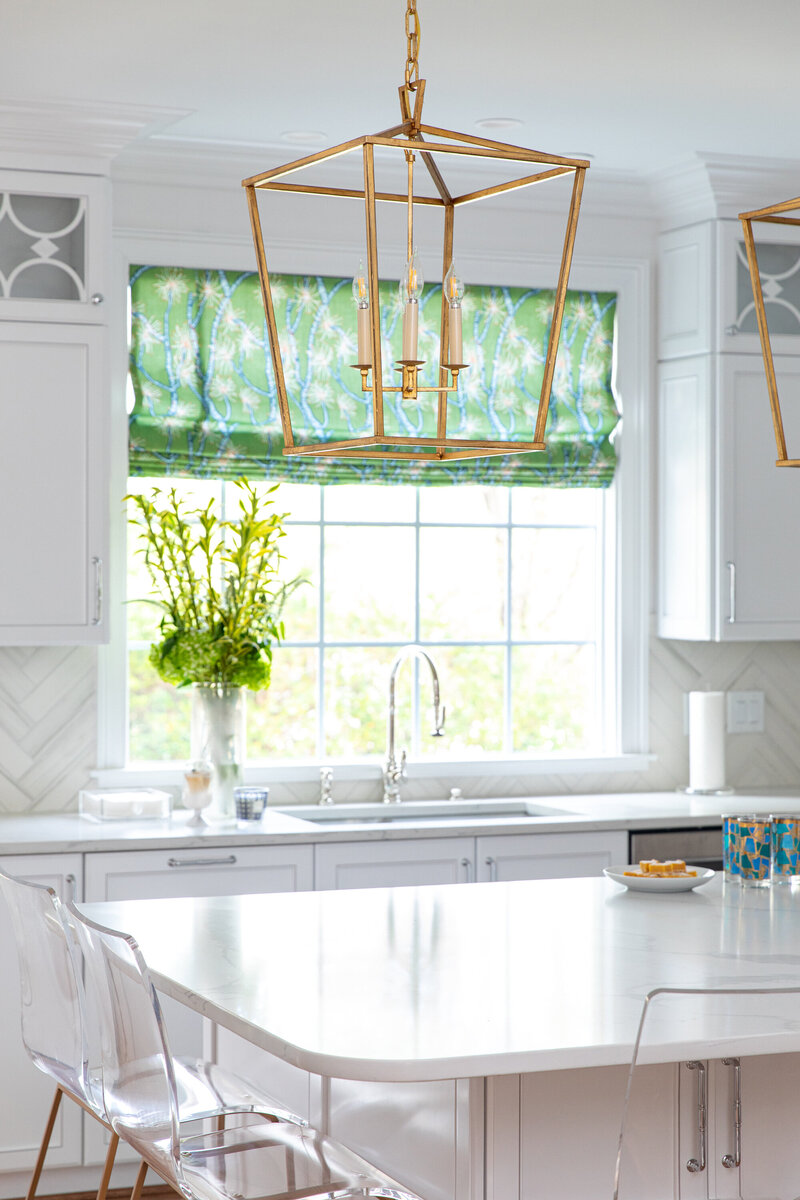 Bright white kitchen with green curtains