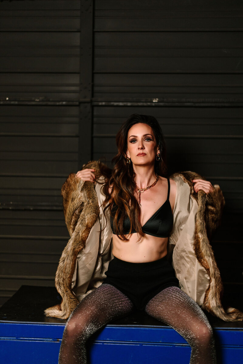 Photo of Juliet Trnka in a fur coat with a dark background