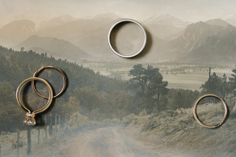 Flat lay of wedding rings laying on top of a mountain landscape image