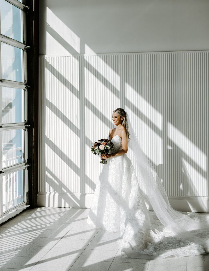 Beautiful bride smiles towards the Hudson river prior to first look and ceremony in New York City, New York