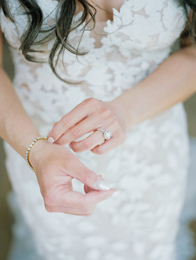A close-up of the bride's wedding ring, showcasing its intricate design and sparkling gemstones.