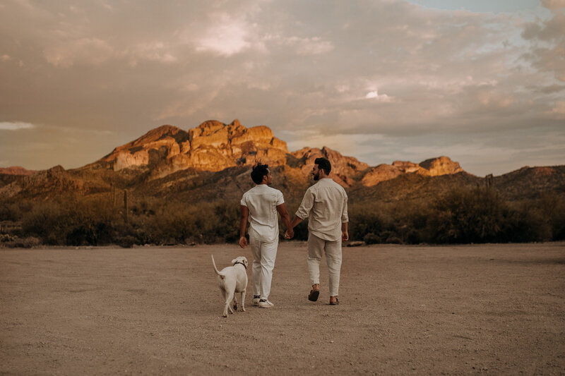 gay couple in white outfit for engagement session  at sunset