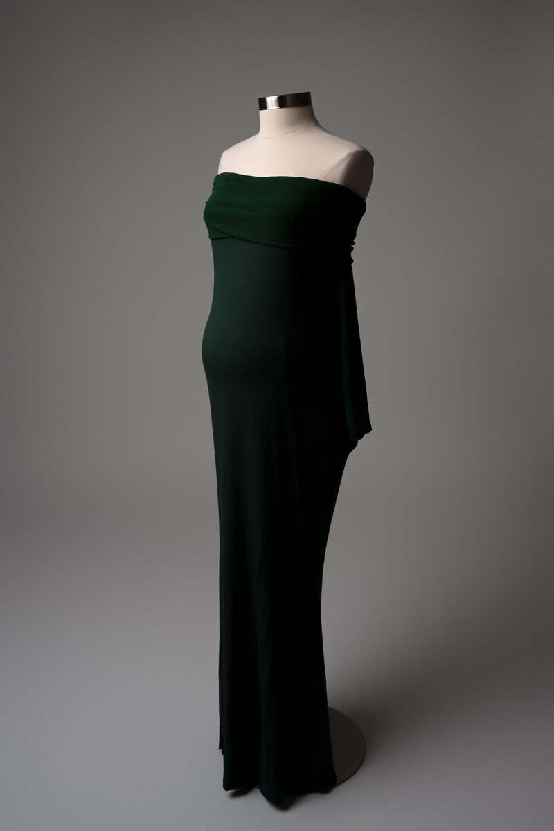 Fitted dark green maternity dress with strapless neckline – styled on mannequin for studio session wardrobe