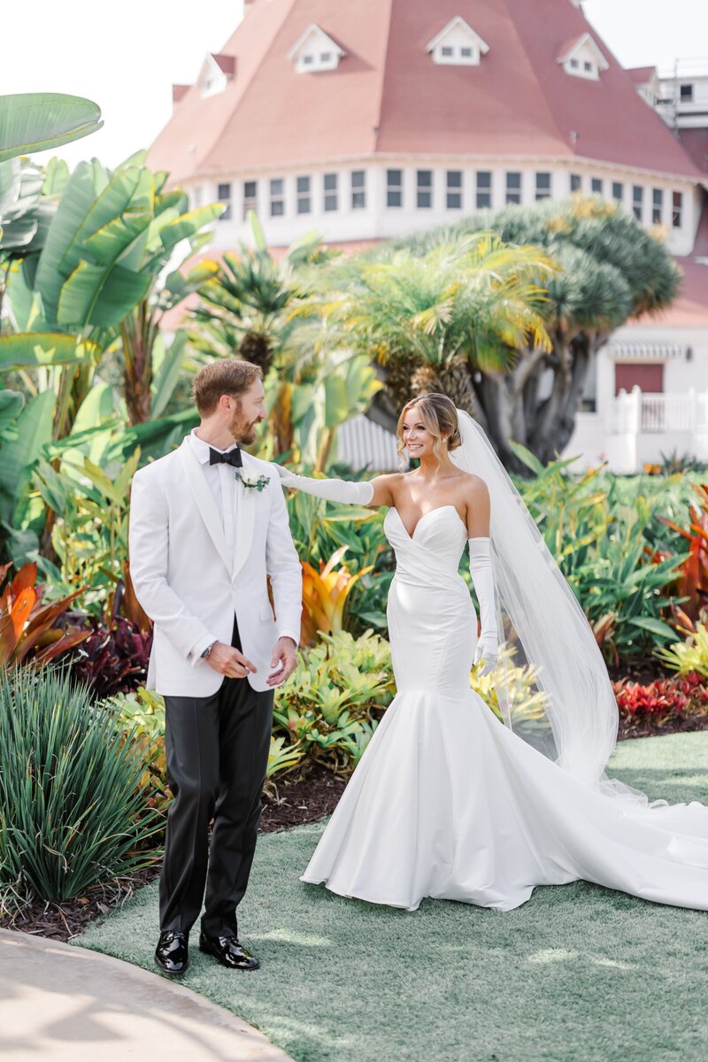 Bride and groom in garden at Hotel del Coronado, designed by Thater Made, a luxury wedding and event producer in San Diego, CA.