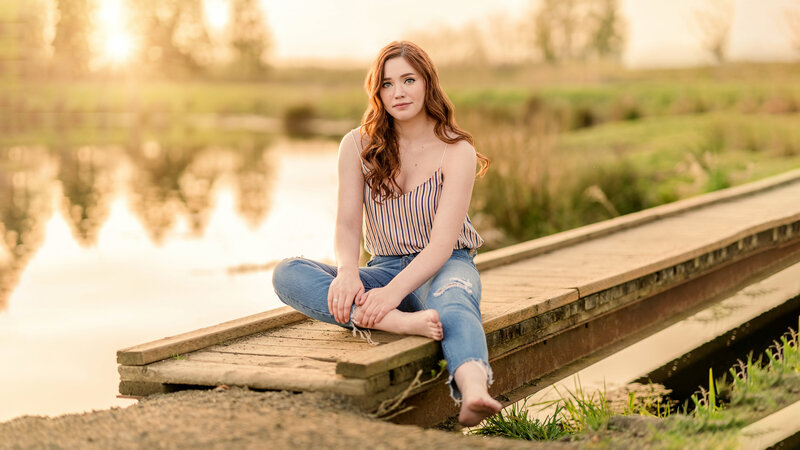 Sunset lake senior portrait photography in Eugene, Oregon for a bold, natural-looking high school senior girl.
