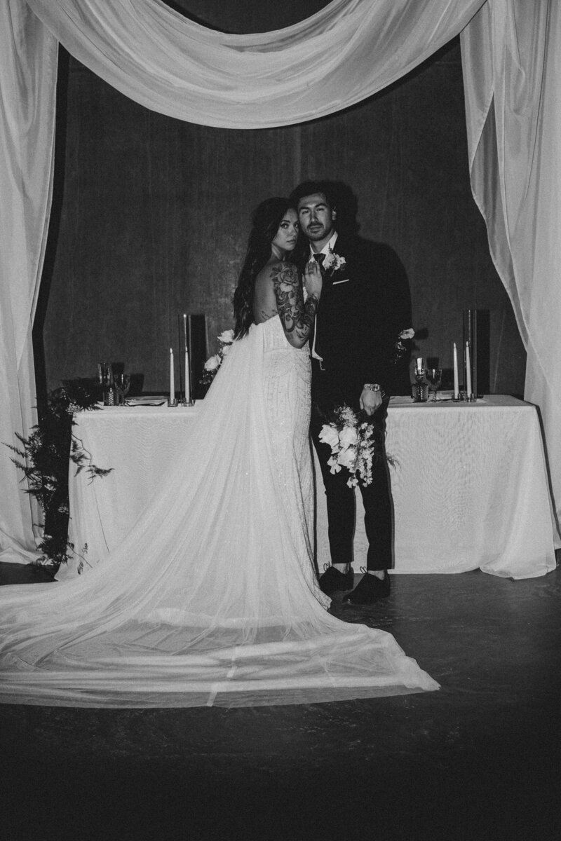 bride-and-groom-with tattoo-at-reception-black-and-white