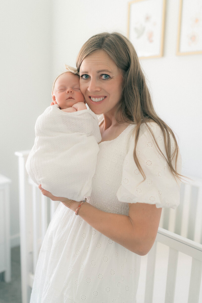 Peaceful at-home newborn photos in South Jordan, Utah, soft whites and tender moments.