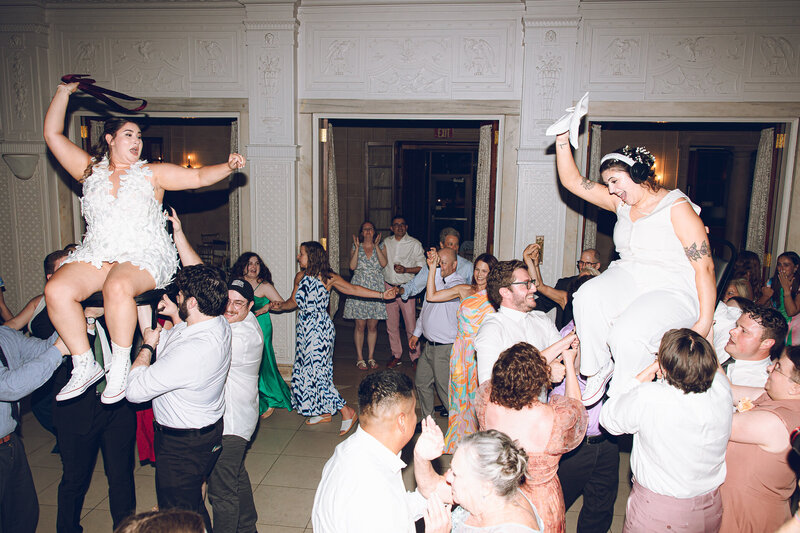 Guests at an intimate queer wedding create flower crowns, captured on film