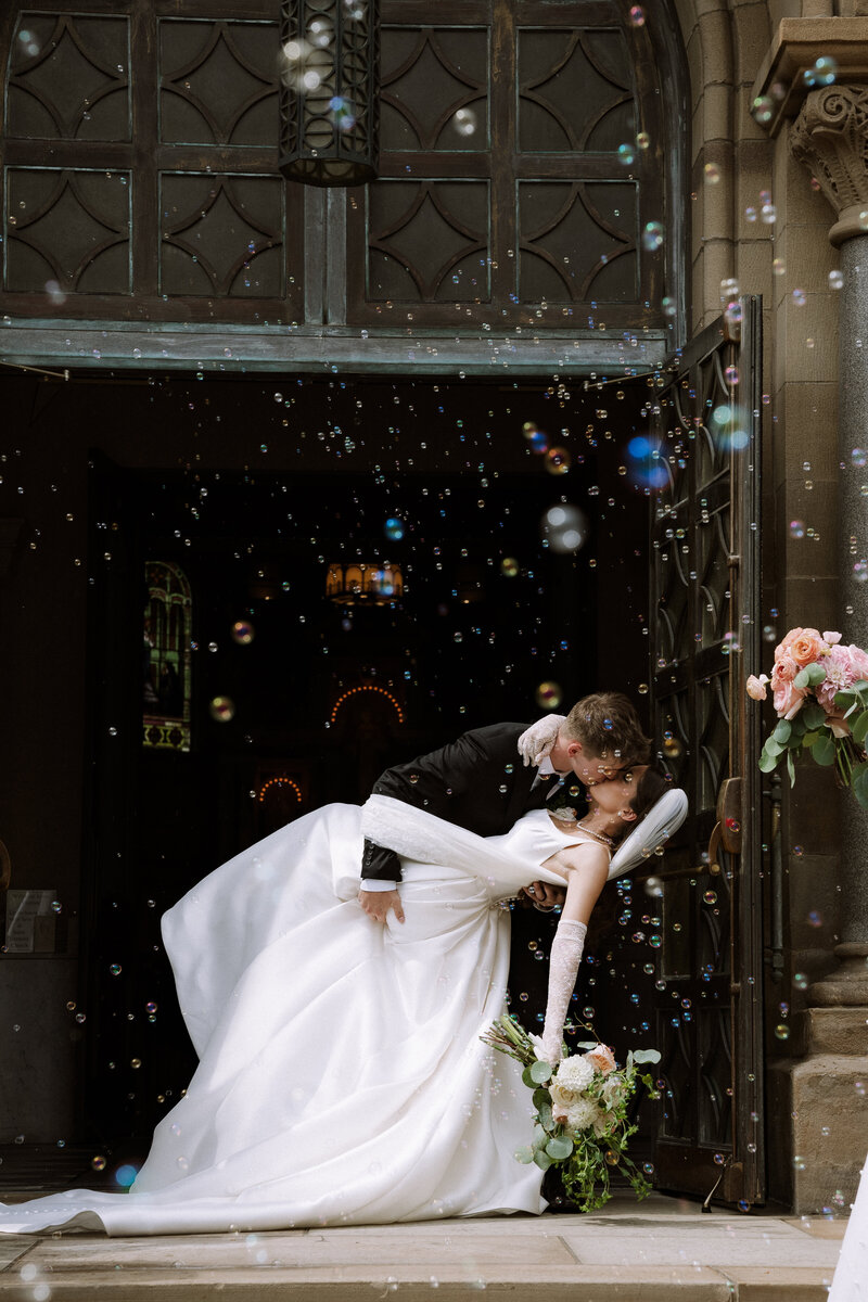 wedding celebration, bride and groom kissing after wedding ceremony, bubbles in air