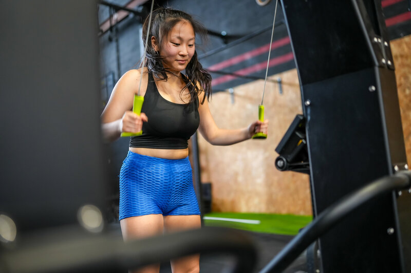 woman-exercising-pulling-weights-with-lat-machine-2024-12-10-02-58-28-utc