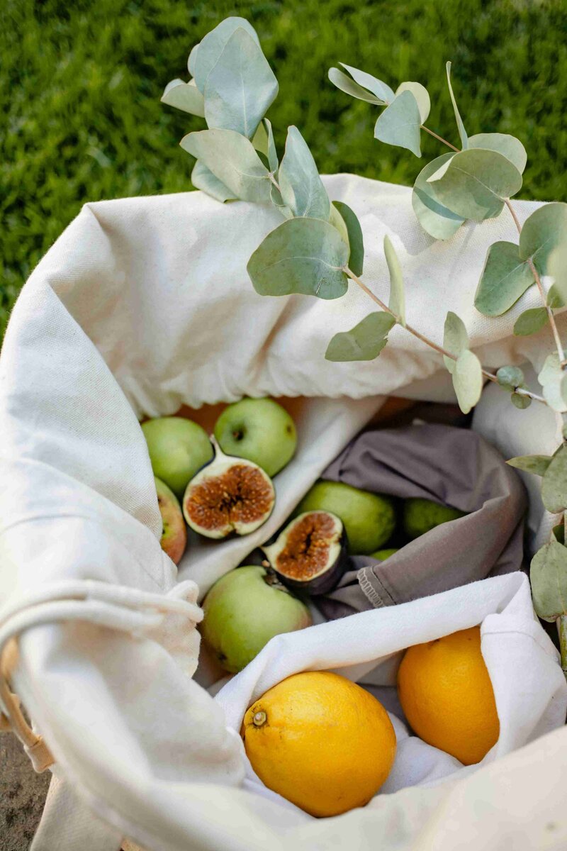 A basket overflowing with fresh lemons, figs, and assorted fruits, set against a Chicago backdrop.