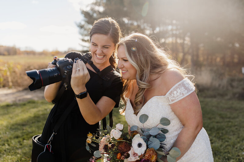 Bride looks at  Minnesota wedding photographer, Morgan Elizabeth Photography's camera  on her wedding day