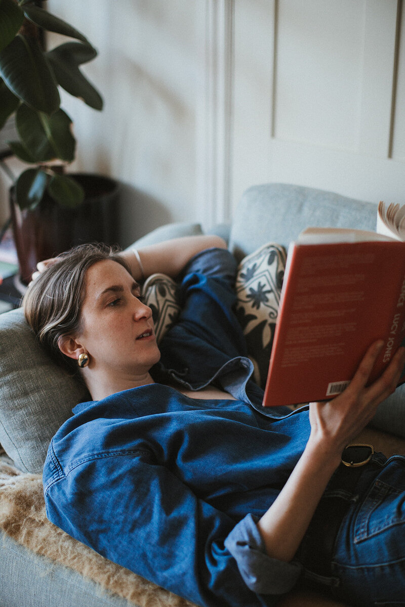 Female business coach reads book empowering mothers