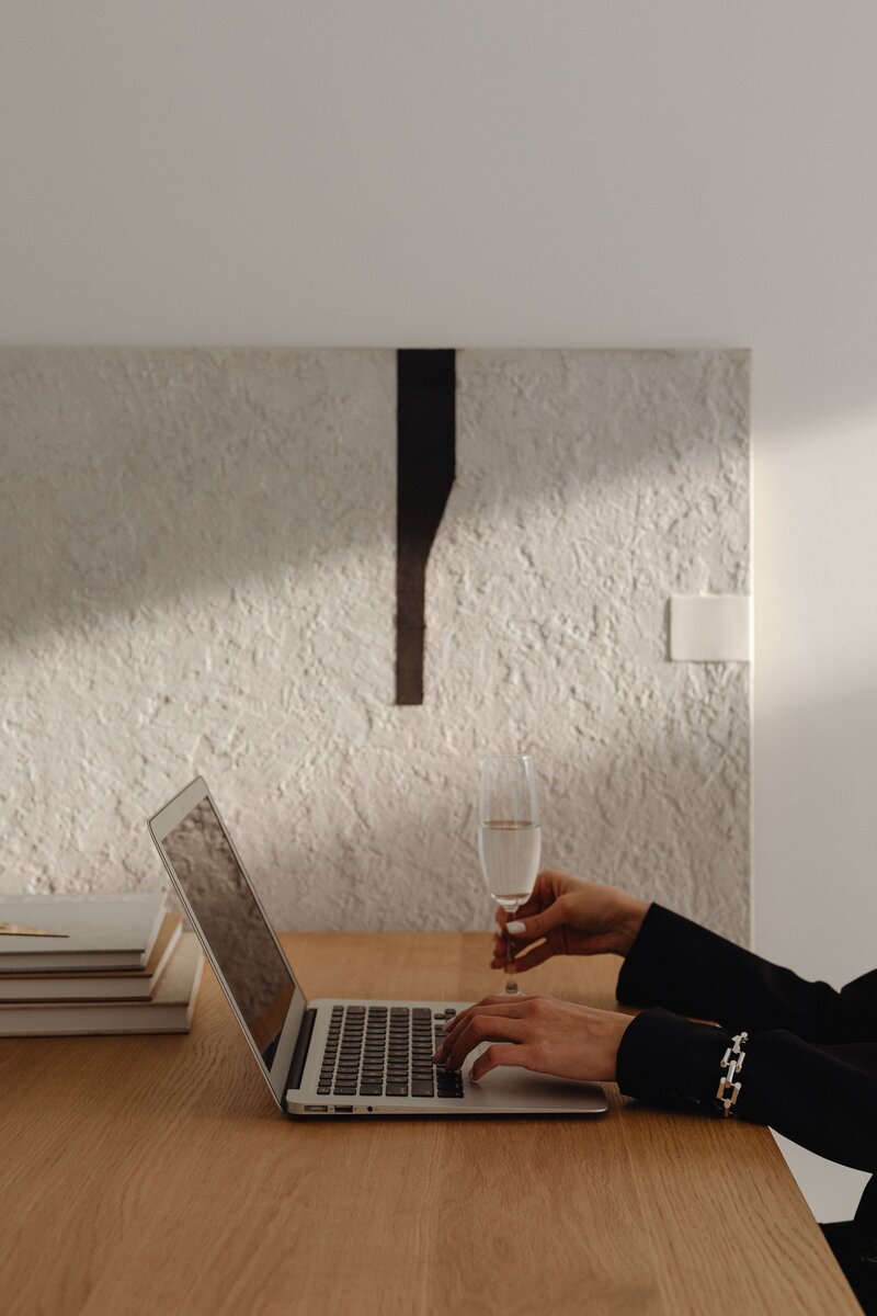 Laptop in a minimalist feminine workspace styled for a creative entrepreneur