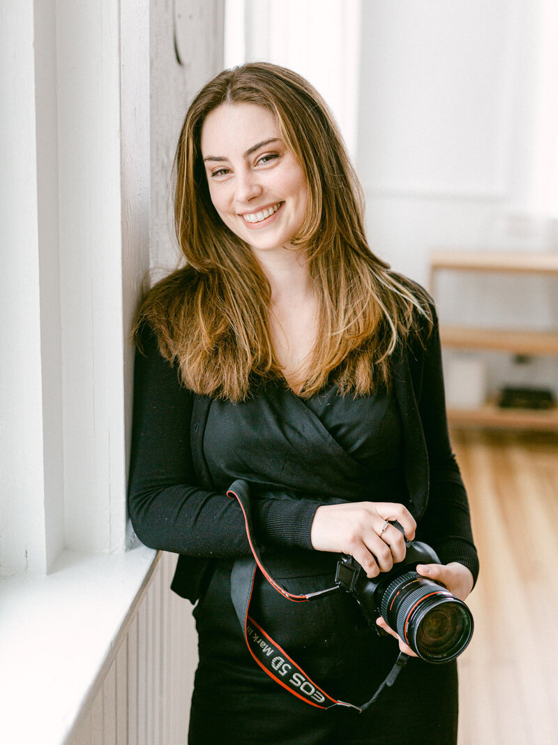 Photographer Holding camera and smiling